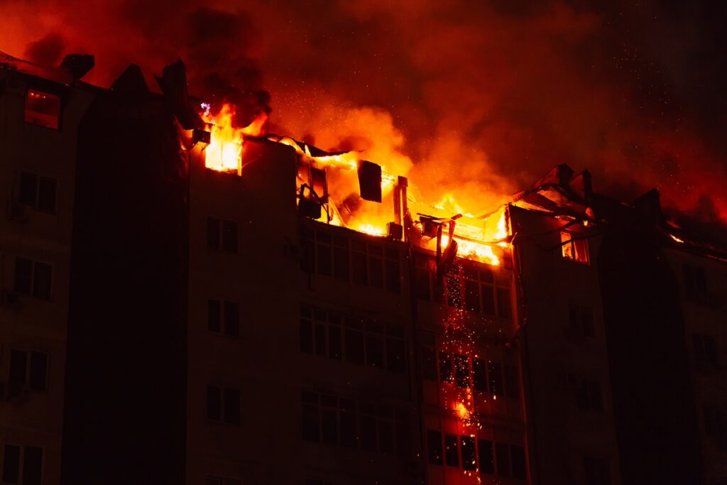 NYC apartment building fire with flames visible from upper floors at night