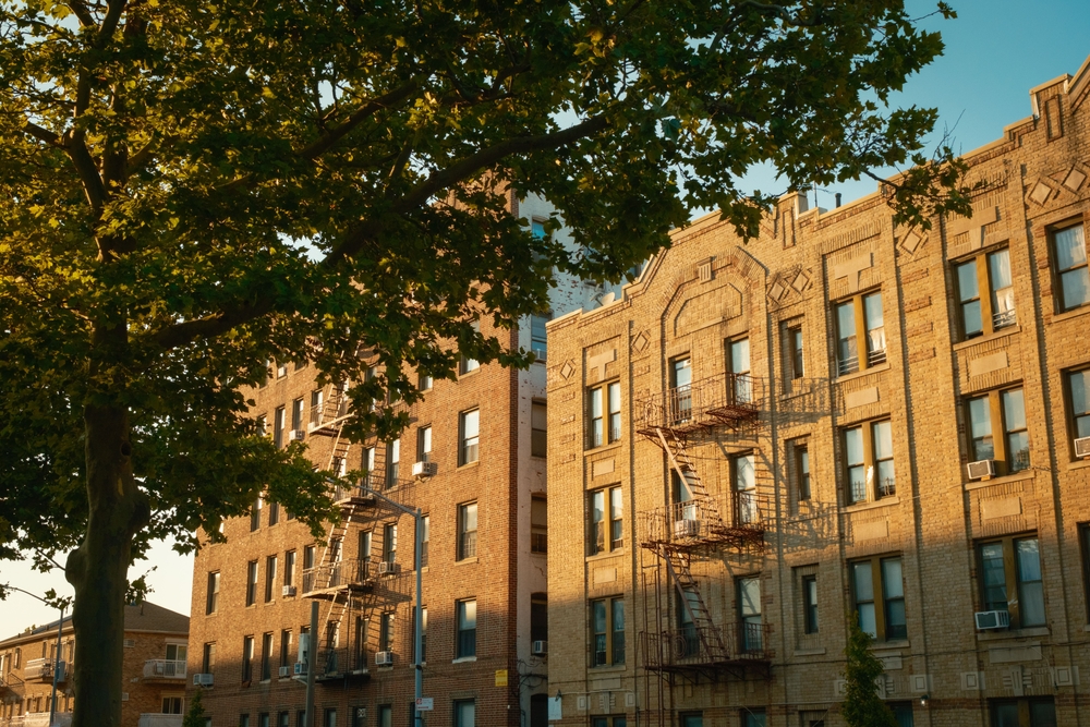 Classic Brooklyn brick apartment building with fire escapes representing residential insurance claims in Brooklyn