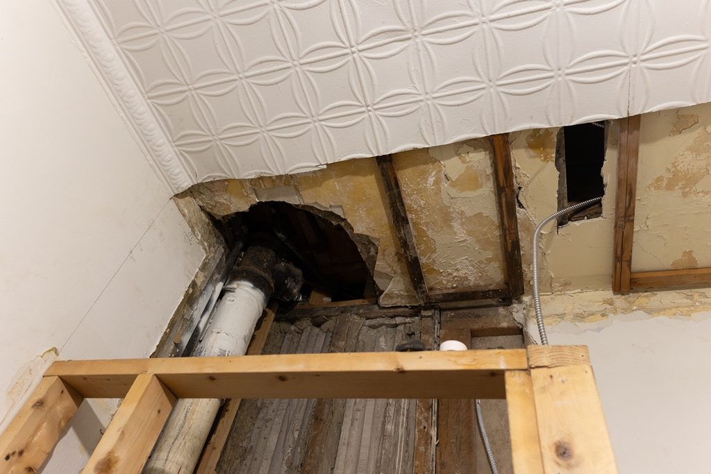 Collapsed ceiling in New York apartment from water damage representing insurance claim for building owners