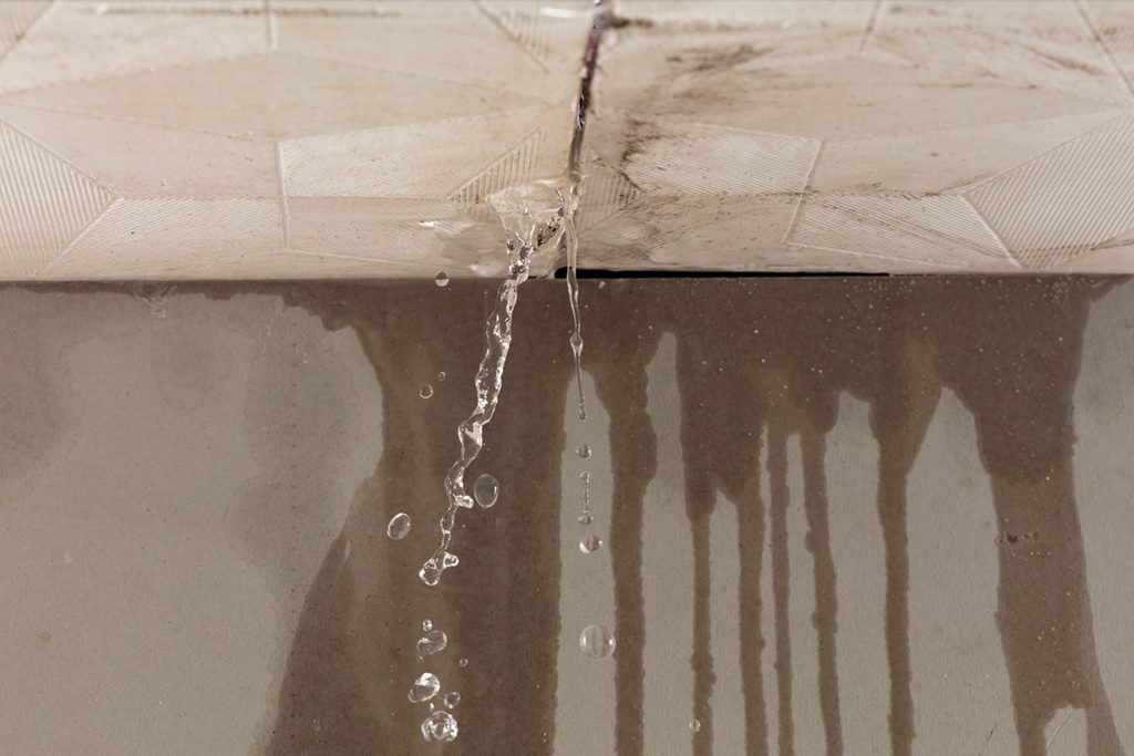 Water leaking through ceiling from roof damage representing insurance claim in New York